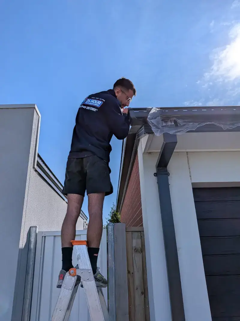 Roof plumber working on gutter in Malvern